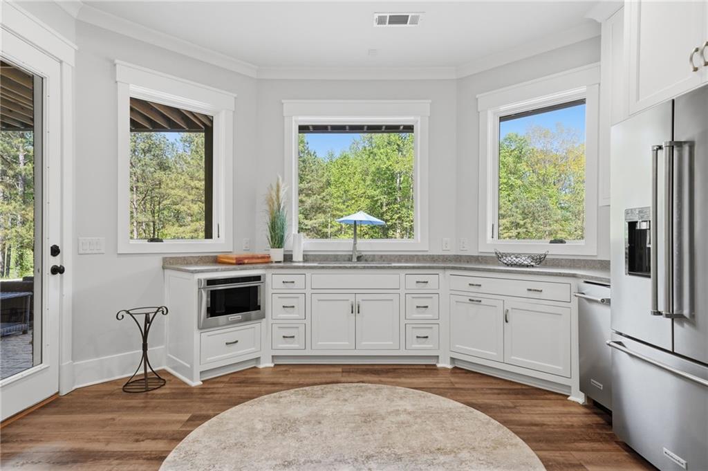 680 Gaddis Road Canton, GA 30115 - Photo 54 of 85 a kitchen with white cabinets and a window