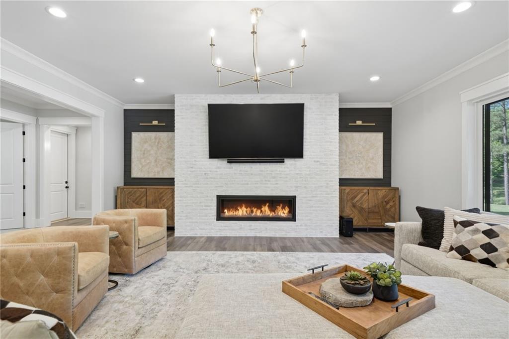 680 Gaddis Road Canton, GA 30115 - Photo 55 of 85 a living room with furniture a flat screen tv and a fireplace