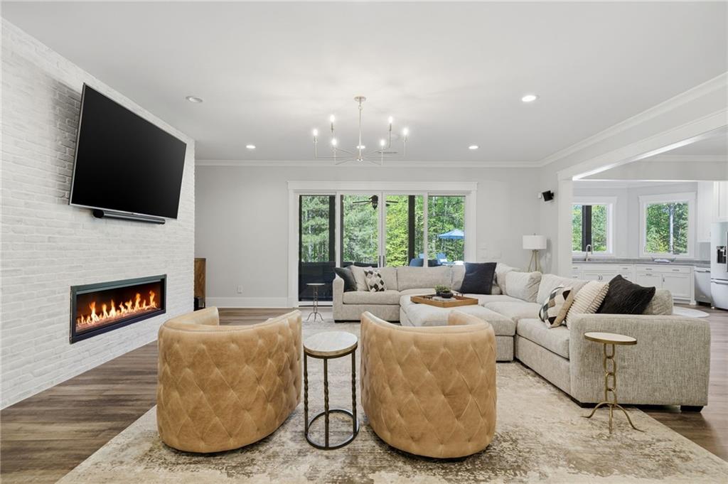 680 Gaddis Road Canton, GA 30115 - Photo 56 of 85 a living room with furniture a fireplace and a flat screen tv
