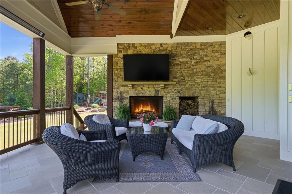 680 Gaddis Road Canton, GA 30115 - Photo 67 of 85 a living room with furniture a flat screen tv and a fireplace