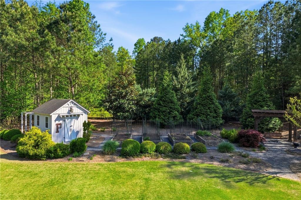680 Gaddis Road Canton, GA 30115 - Photo 71 of 85 a house with green field in front of it
