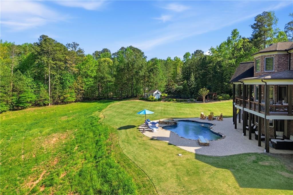680 Gaddis Road Canton, GA 30115 - Photo 79 of 85 an aerial view of a house with swimming pool garden and trees