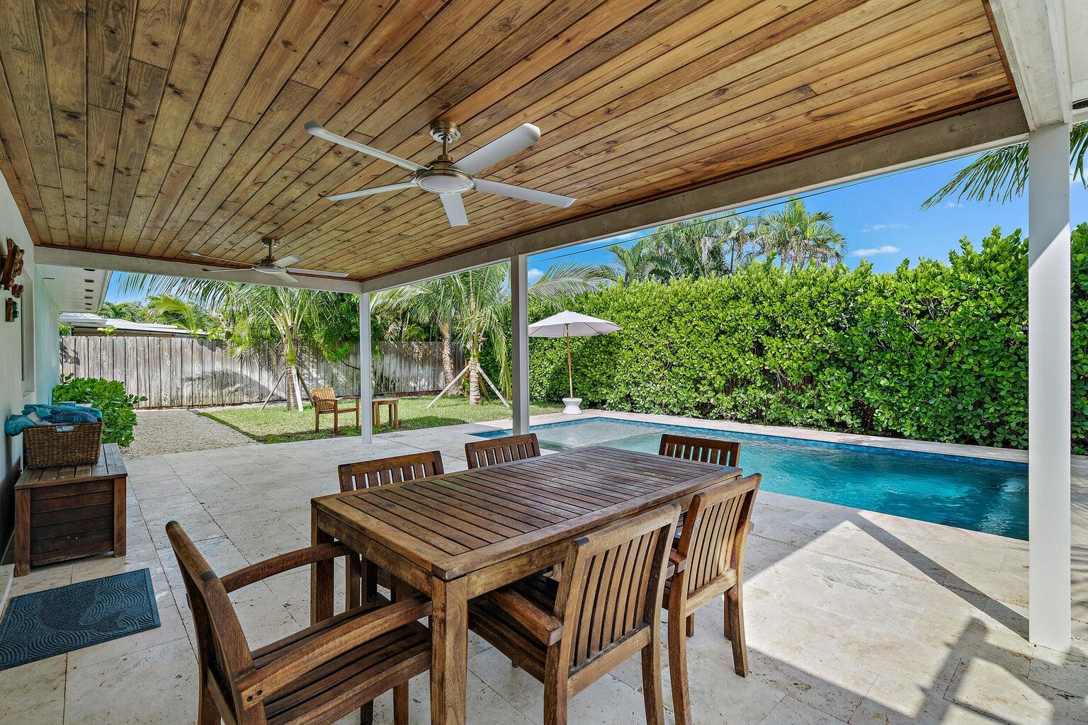 356 Mars Avenue Tequesta, FL 33469 - Photo 5 of 25 a view of an outdoor sitting area with wooden furniture