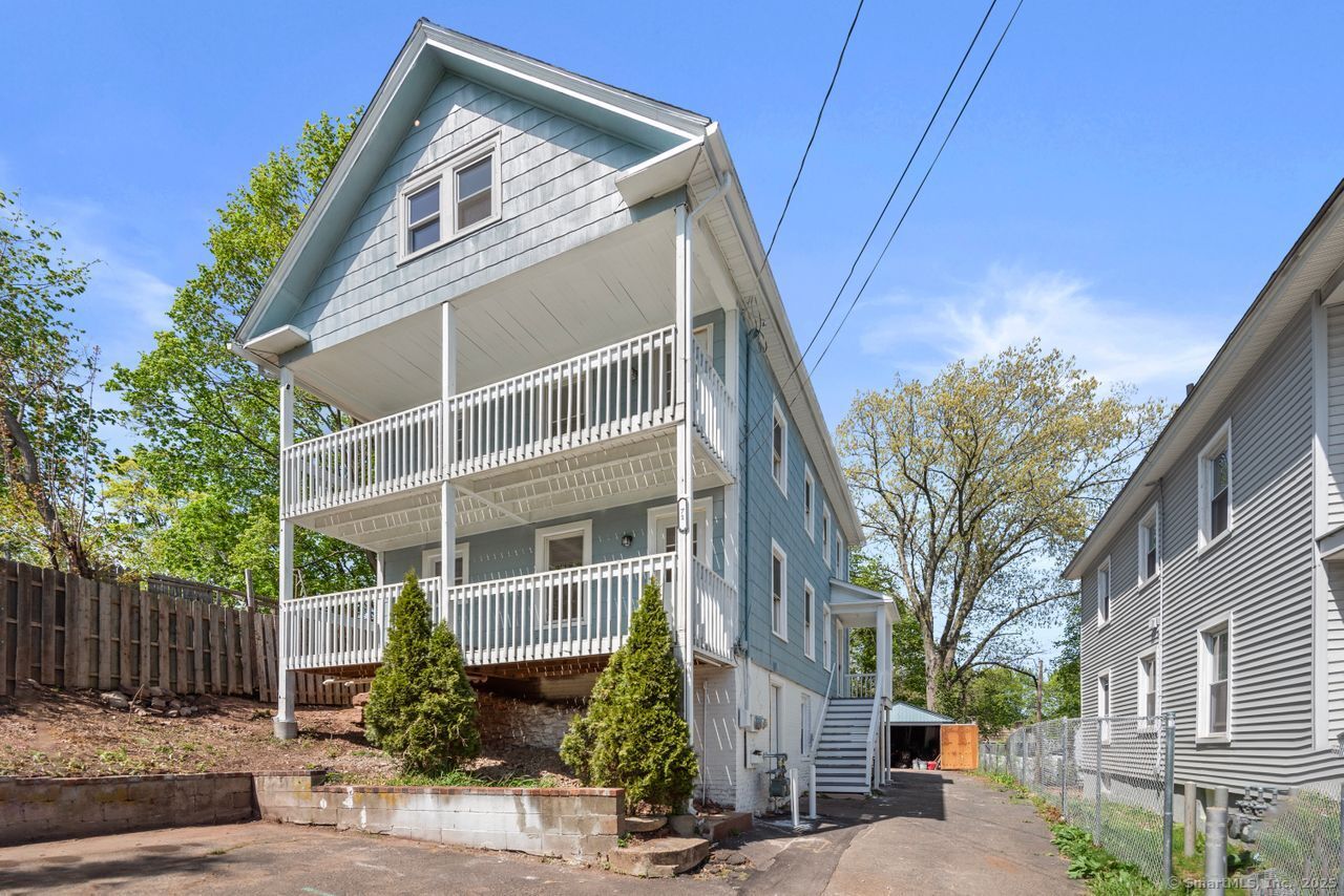 a front view of a house with plants