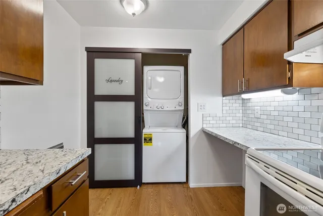 a kitchen with kitchen island sink and refrigerator