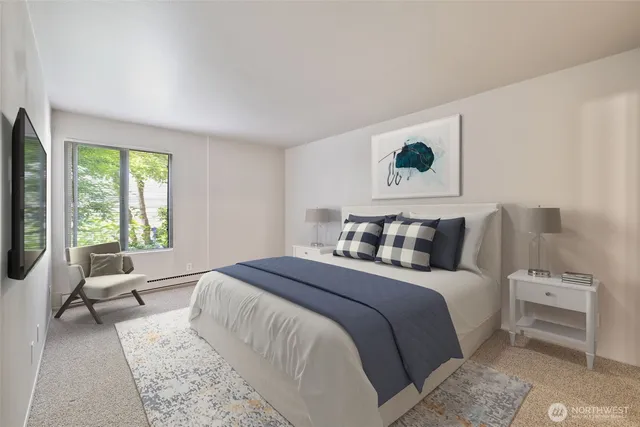 a bed room with a bed a couch and a window