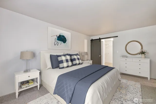 a bathroom with a granite countertop toilet a sink and a mirror