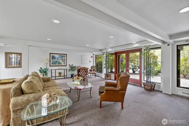 a living room with furniture and large windows