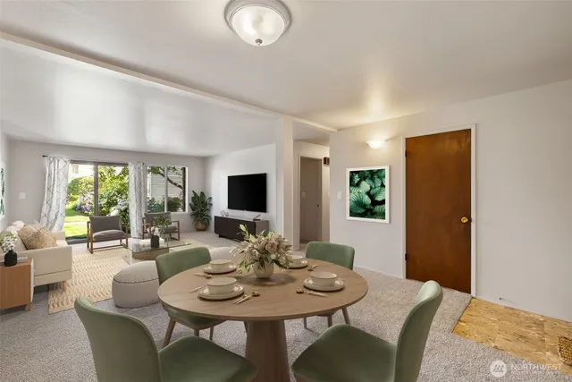 a view of a dining room with furniture and a large window