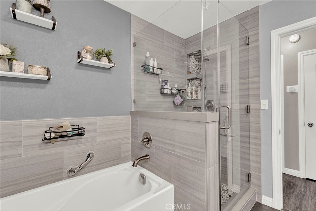 133 East Van Koevering Street Rialto, CA 92376 - Photo 12 of 23 a bathroom with a sink a mirror and shower