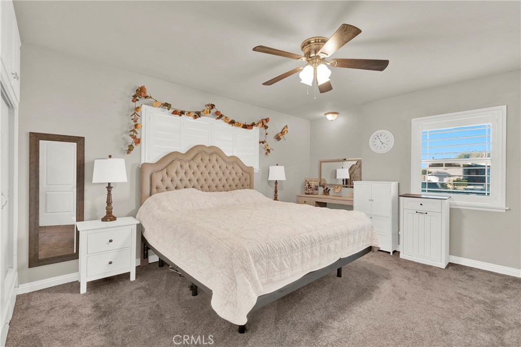 133 East Van Koevering Street Rialto, CA 92376 - Photo 14 of 23 a bedroom with a bed and a chandelier