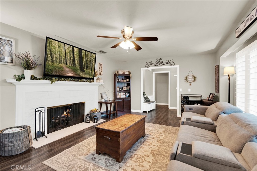 133 East Van Koevering Street Rialto, CA 92376 - Photo 6 of 23 a living room with furniture a flat screen tv and a fireplace