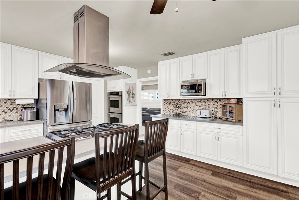 133 East Van Koevering Street Rialto, CA 92376 - Photo 9 of 23 a kitchen with stainless steel appliances granite countertop a stove a sink and a refrigerator