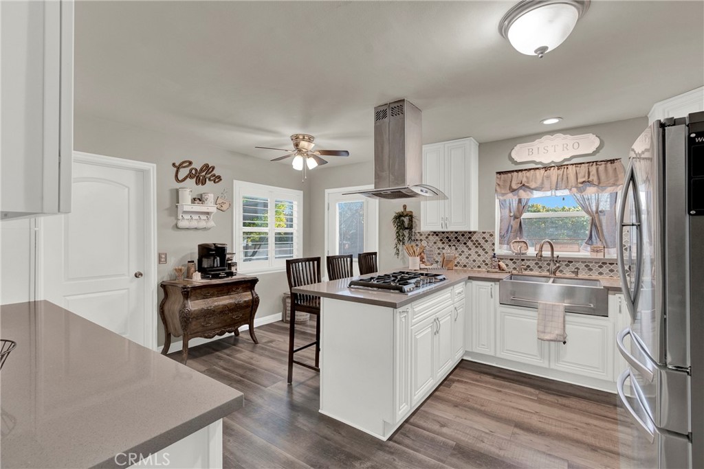 133 East Van Koevering Street Rialto, CA 92376 - Photo 10 of 23 a kitchen with a stove a sink and a refrigerator