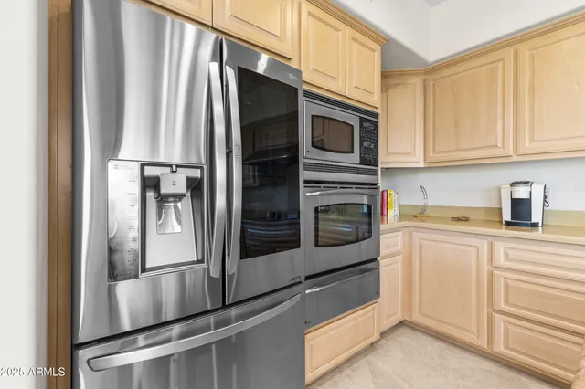 a kitchen with stainless steel appliances and cabinets