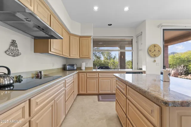 a kitchen with a sink cabinets and window