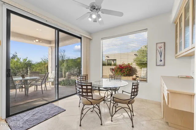 a dining room with furniture a chandelier and wooden floor