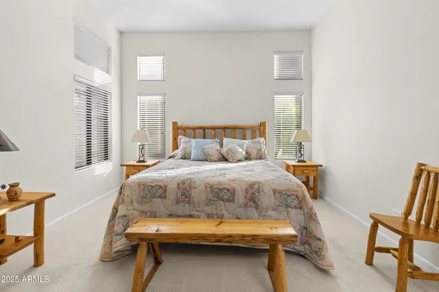 a bedroom with a bed and a chair