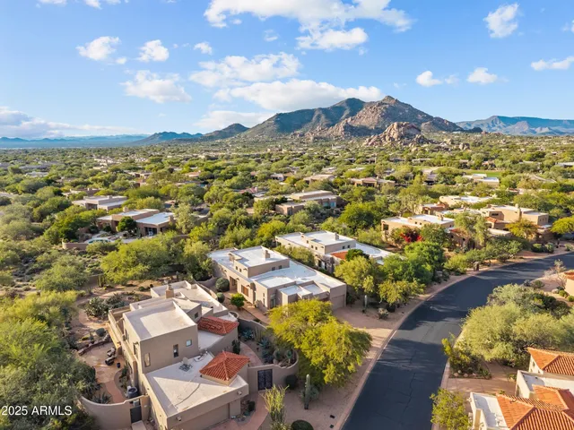 an aerial view of residential houses with outdoor space