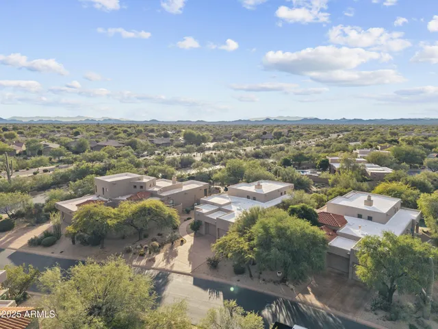 an aerial view of residential houses with outdoor space and swimming pool