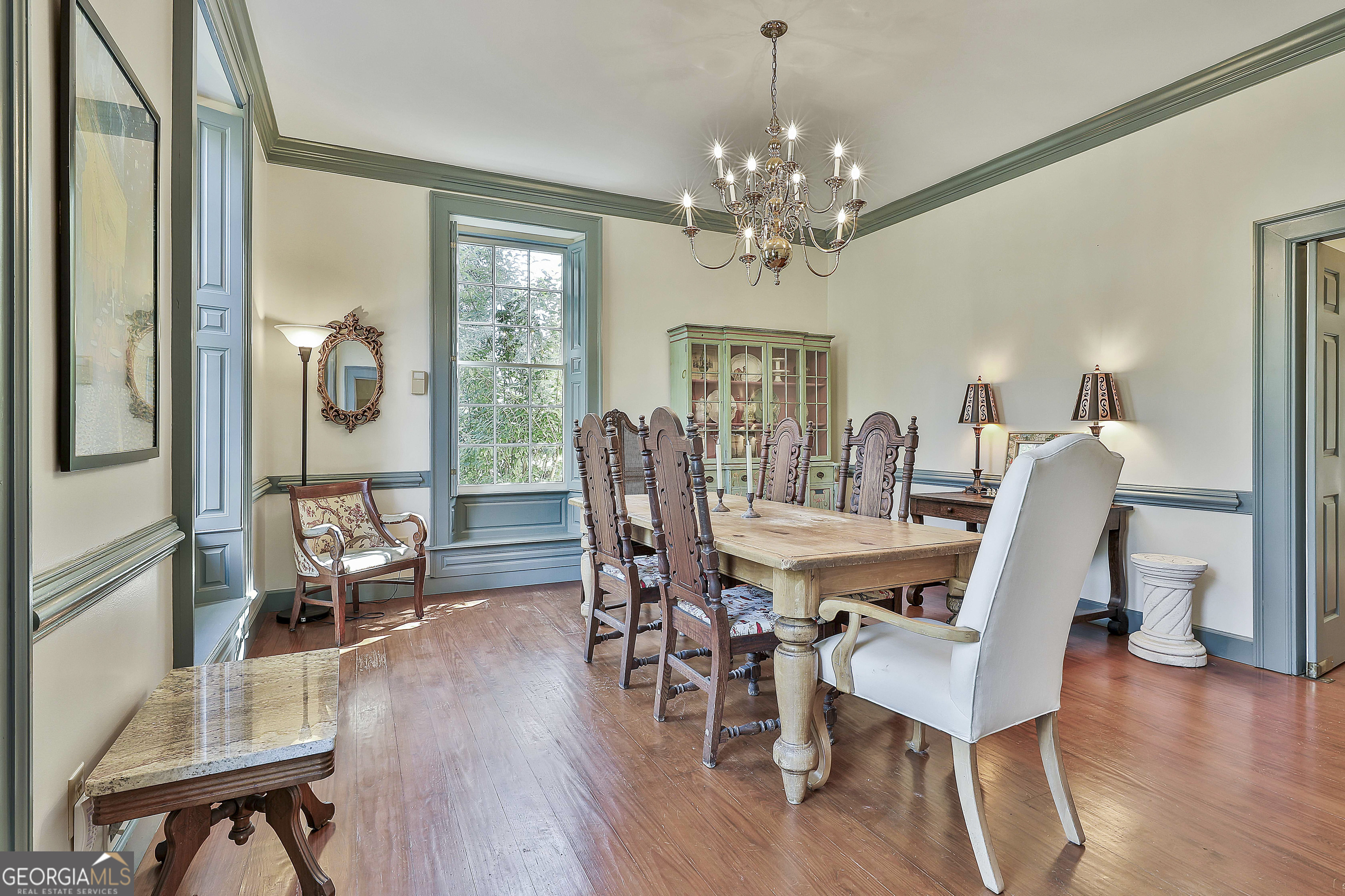 405 North Pine Hill Road Griffin, GA 30223 - Photo 13 of 72 a view of a dining room with furniture wooden floor and chandelier