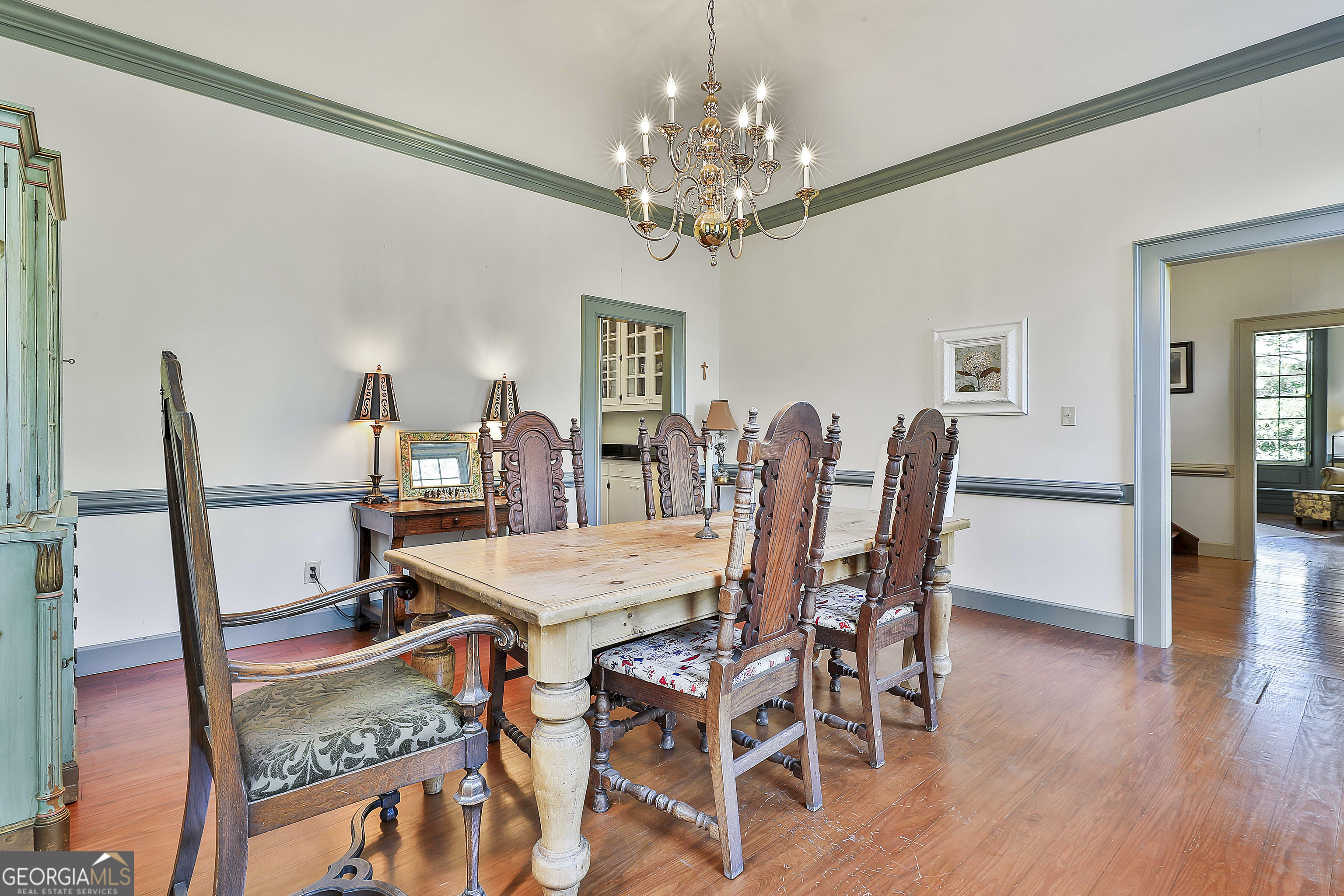 405 North Pine Hill Road Griffin, GA 30223 - Photo 16 of 72 a view of a dining room with furniture and wooden floor