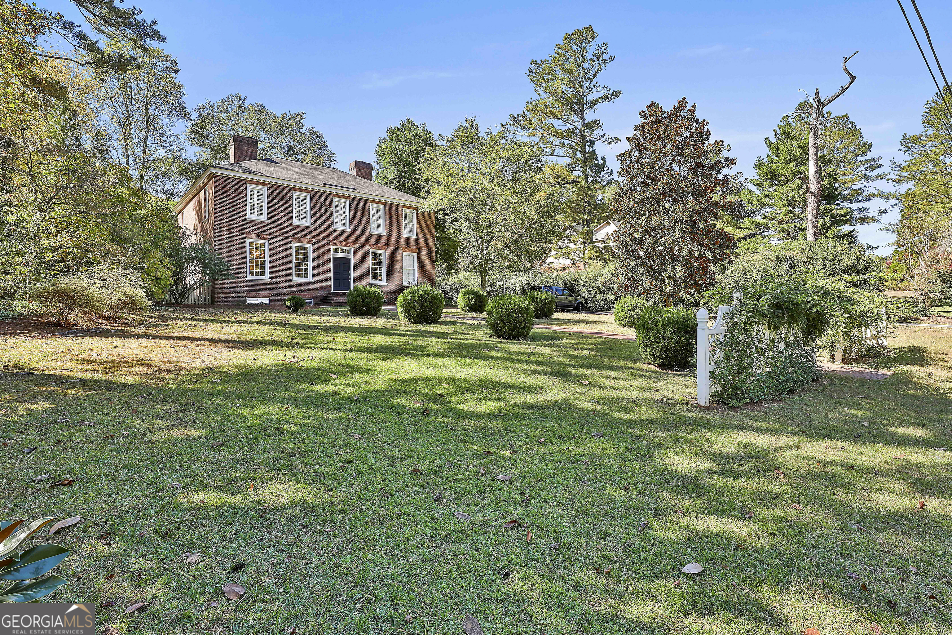 405 North Pine Hill Road Griffin, GA 30223 - Photo 2 of 72 a view of a big building with big yard and large trees