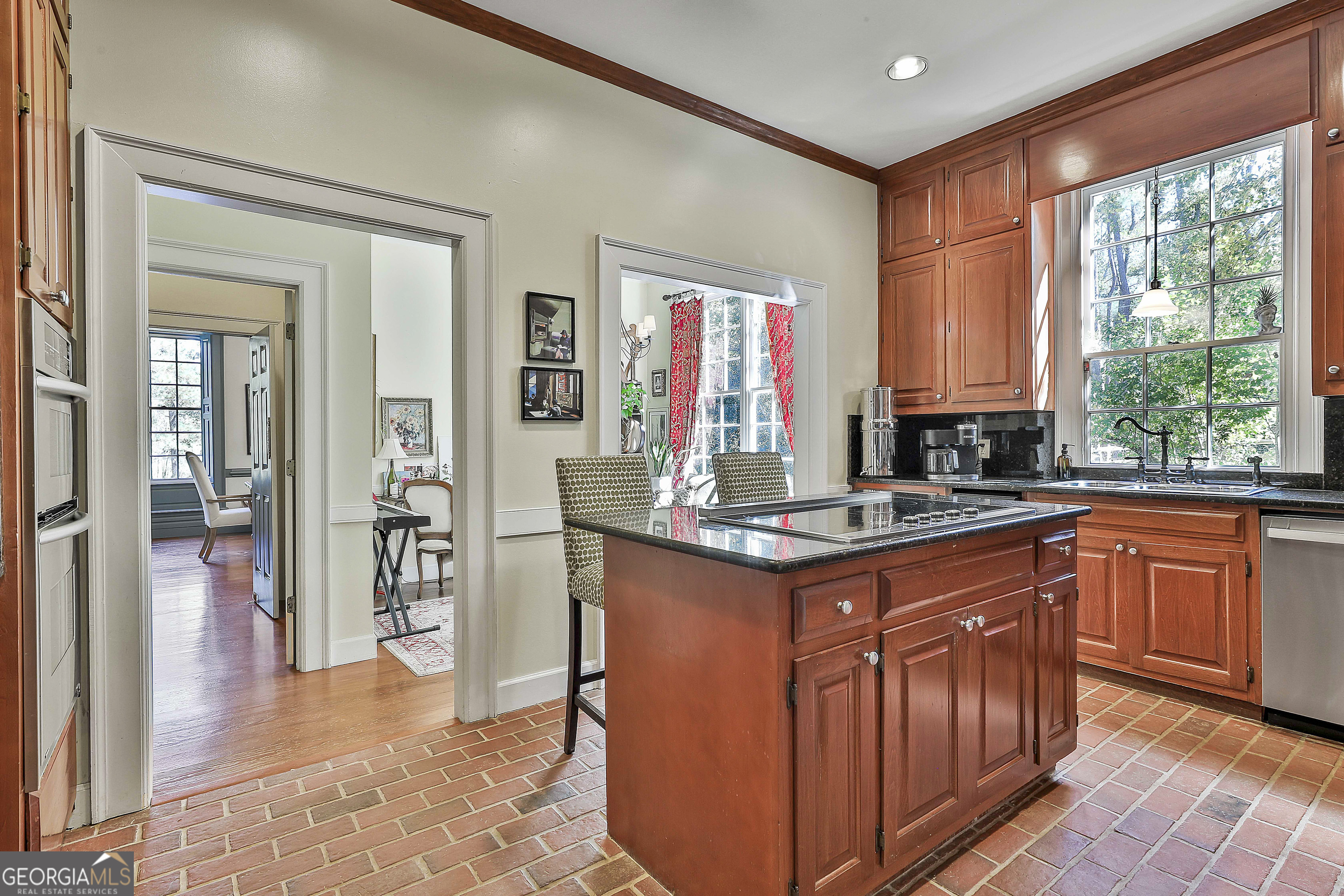 405 North Pine Hill Road Griffin, GA 30223 - Photo 24 of 72 a kitchen with stainless steel appliances granite countertop a stove a sink and a refrigerator