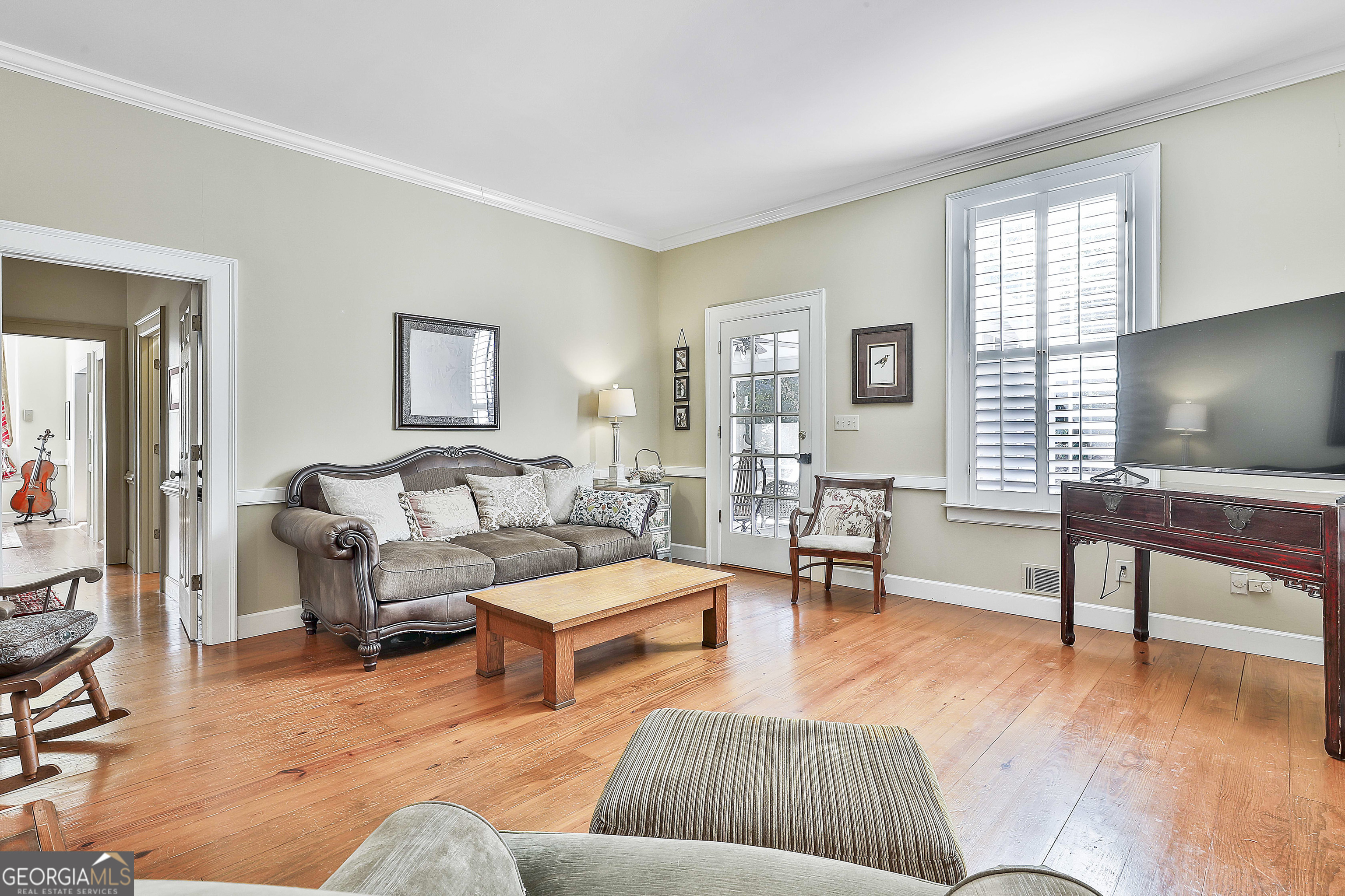 405 North Pine Hill Road Griffin, GA 30223 - Photo 31 of 72 a living room with furniture and a wooden floor
