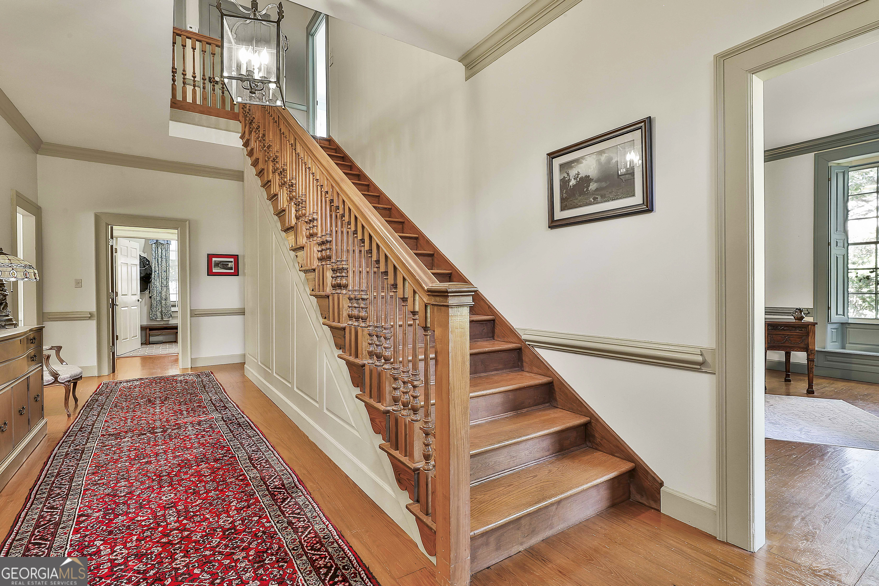 405 North Pine Hill Road Griffin, GA 30223 - Photo 34 of 72 a view of staircase with lots of frames on wall and windows