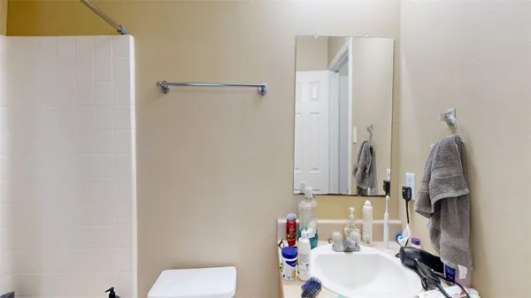 a bathroom with a sink toilet and shower