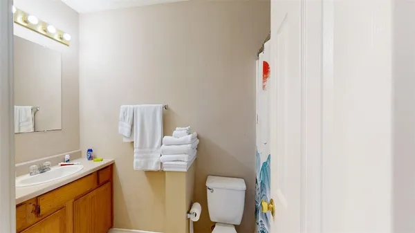 a bathroom with a sink toilet and vanity
