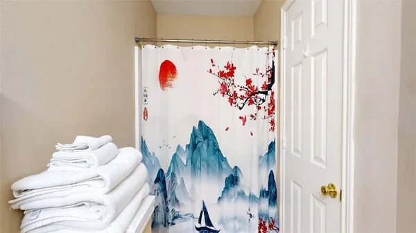 a view of a hallway with couch and white walls