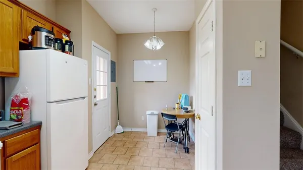 a view of kitchen with furniture and refrigerator
