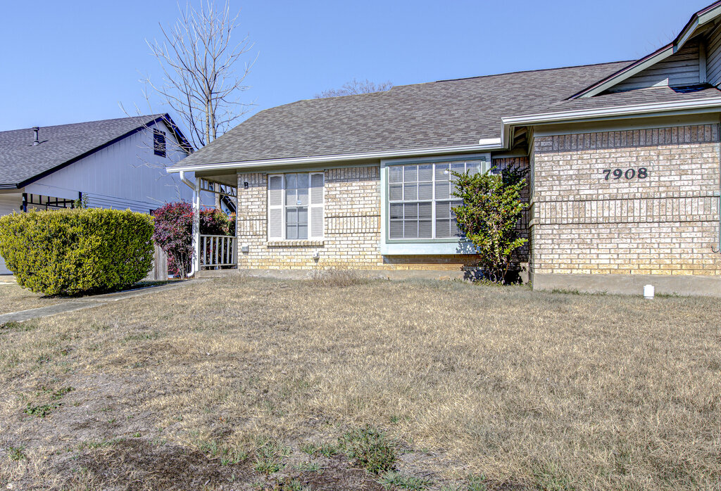 7908 West Gate Boulevard, Unit B Austin, TX 78745 - Photo 2 of 23 View of front of home featuring brick siding, roof with shingles, and a front lawn