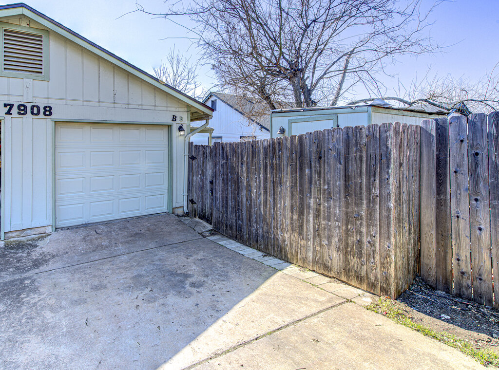 7908 West Gate Boulevard, Unit B Austin, TX 78745 - Photo 3 of 23 Detached garage featuring driveway