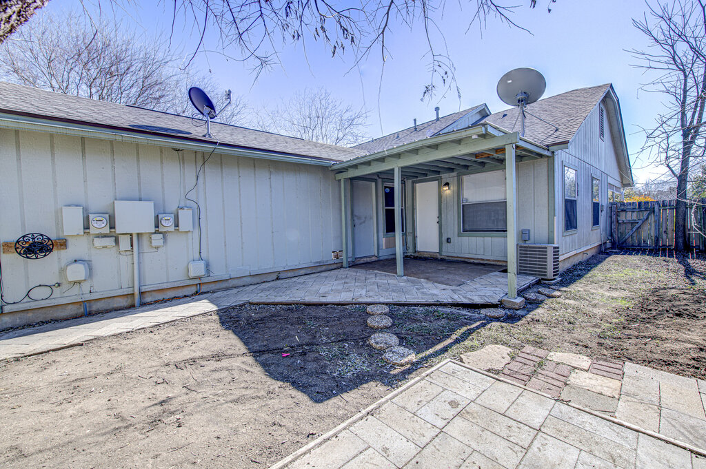 7908 West Gate Boulevard, Unit B Austin, TX 78745 - Photo 5 of 23 Back of property with a shingled roof, a patio area, a gate, and board and batten siding