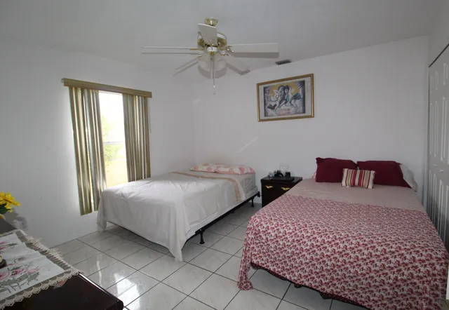 a bedroom with two beds and a window