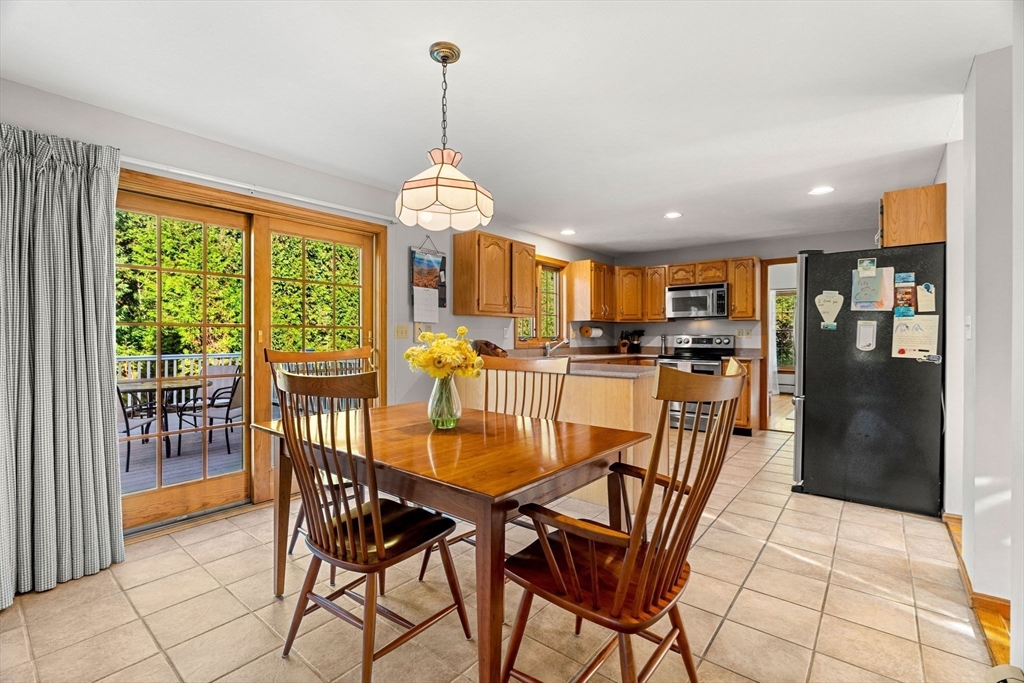 1 Stacey Lane Amesbury, MA 01913 - Photo 11 of 41 a view of a dining room and livingroom with furniture wooden floor a chandelier