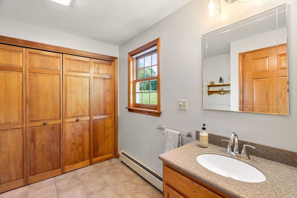1 Stacey Lane Amesbury, MA 01913 - Photo 20 of 41 a bathroom with a sink and a mirror