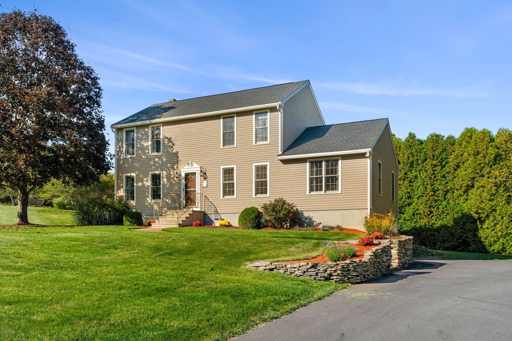 1 Stacey Lane Amesbury, MA 01913 - Photo 2 of 41 a front view of a house with a yard