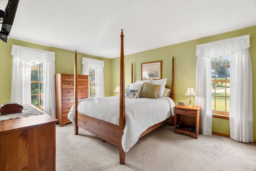 1 Stacey Lane Amesbury, MA 01913 - Photo 28 of 41 a bedroom with a bed and wooden floor