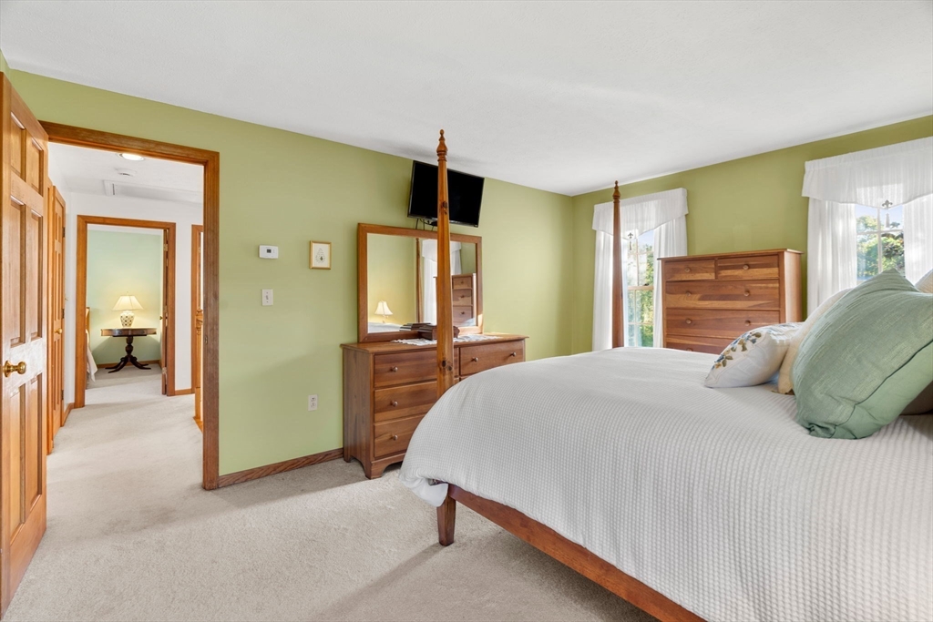 1 Stacey Lane Amesbury, MA 01913 - Photo 30 of 41 a bedroom with a bed and a flat tv screen