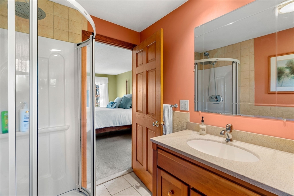 1 Stacey Lane Amesbury, MA 01913 - Photo 31 of 41 a en suite bathroom with a sink a mirror and a shower