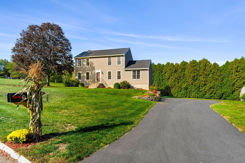 1 Stacey Lane Amesbury, MA 01913 - Photo 4 of 41 a front view of a house with garden