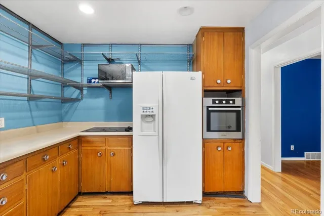 a kitchen with a refrigerator and cabinets