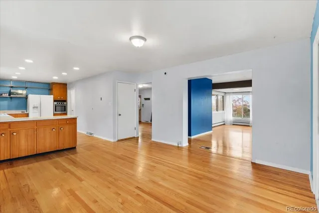 a view of empty room with wooden floor