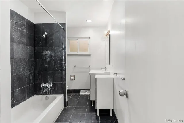 a bathroom with a bathtub and a shower