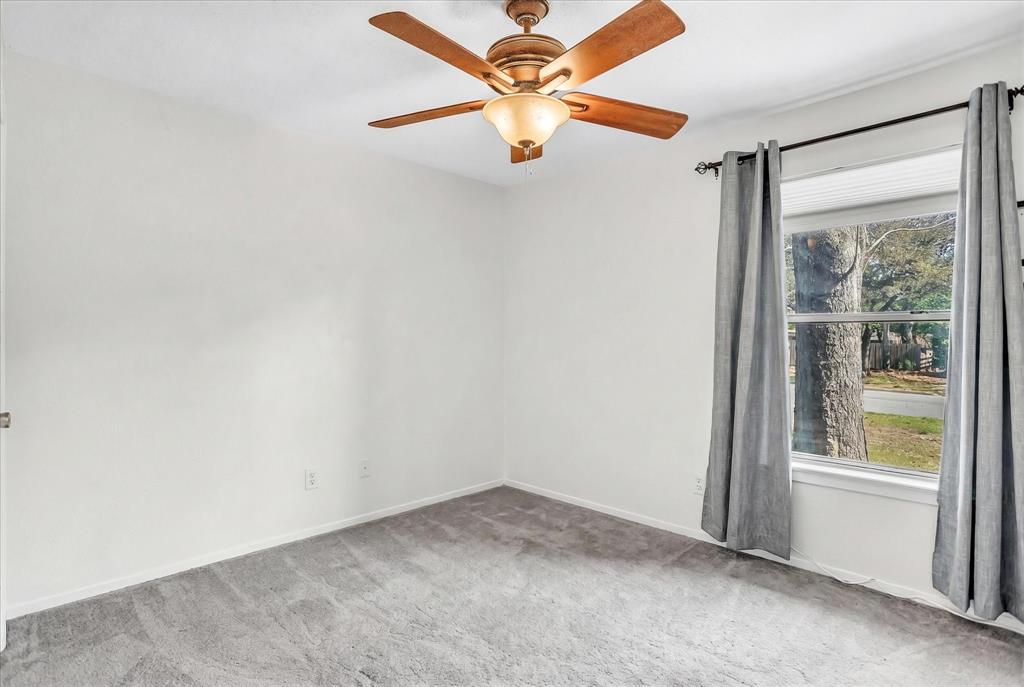 709 Hurstview Drive Hurst, TX 76053 - Photo 15 of 28 an empty room with a window and a fan