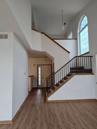 a view of entryway and hall with wooden floor